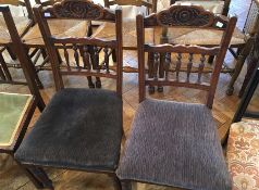 A pair of Edwardian carved walnut dining