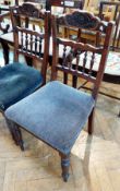 A pair of Edwardian carved walnut dining