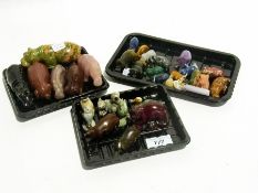 A collection of carved animals including Unakite gold stone, agate and tiger eye stone hippopotami,