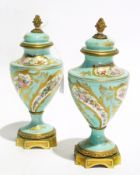 A pair of Sevres porcelain lidded urns w