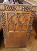 An oak church pew with gothic floral car