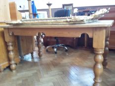 A pine farmhouse style dining table with