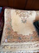 Eastern wool rug, beige ground with predominantly blue and red floral decoration,