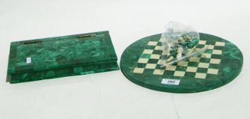 A malachite and marble chess board with chess pieces and a malachite specimen box