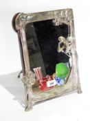 An Art Nouveau design silvered frame naturalistic bordered rectangular table mirror with trestle