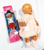 A 1930's composition doll with sleeping eyes,