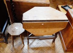 An oak drop-flap octagonal top gate-leg table on turned legs united by stretchers,