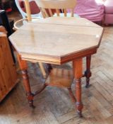 A Victorian octagonal side table on block and fluted supports and brass castors