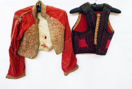 Two boxes of assorted Edwardian clothes including waistcoats, many altered and adjusted for 