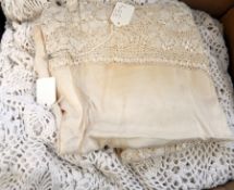 A pair of crocheted single bed covers, another in wool with a satin and lace table cover (1 box)