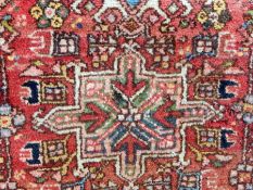 Oriental pattern wool rug with three medallions, in a pink field, floral design together with a