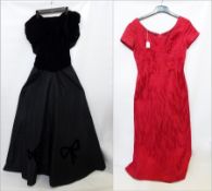 A black velvet and satin evening dress, the bodice ruched with drop waist and black velvet bows