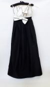 A white and black evening dress by Yvette, the bodice with white shaped leaves, a bow to the front