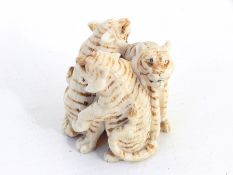 Carved model showing three tigers with painted detail (af)