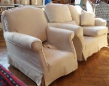 Two-seater sofa with loose cushions and matching armchair with beige upholstery