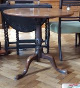 Georgian mahogany circular tilt-top tripod table on carved column support to tripod splayed legs,