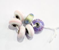 Six authentic troll beads including two with pansy decoration