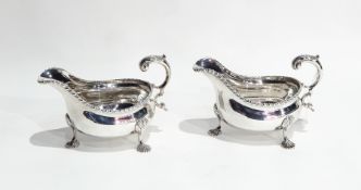 Pair Edwardian George III style sauceboats with gadrooned border, engraved crest above initial 
