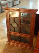 A Georgian style hardwood glazed corner cupboard with astragal glazing, enclosing shelf,