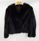 A dark mink coat labelled 