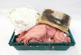 A cotton bedspread in pink and a satin pillow with a painted landscape of a woman on a boat on a