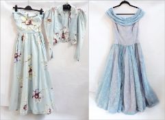 A 1950's silk evening dress with matching jacket, full petticoat and skirt with the base of the