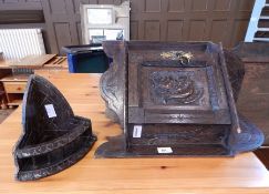 A Victorian oak corner cabinet with stiff leaf carving and Roman warriors head,
