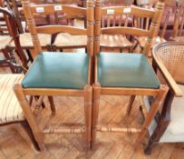 A pair of modern beech bar chairs with upholstered seats on turned legs