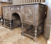 A Jacobean style carved oak sideboard,