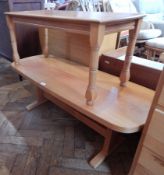 A teak dining table with supports united by a single splat and a coffee table
