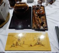 A wooden carved shoe horn in the shape of a duck, an American Indian style carved longboat,