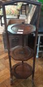 A mid 20th century oak three tier cake stand with beadwork decoration