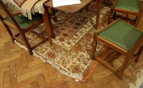 A Persian style rug with cream field and geometric stylised floral decoration,