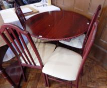 A modern mahogany effect dining table, with rope twist border,