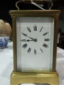 Early 20th century brass carriage clock, plain enamel dial, Roman numerals,