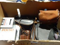 A large quantity of cameras in cases to include a Pentax 10x24 UCF3 and others