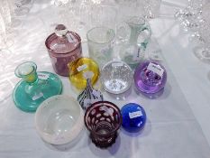 A quantity of decorative glassware to include paperweights, small studio glass bottle necked vase,
