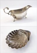 George V silver gravy boat with gadrooned borders, scroll handle, on shell pad feet, Sheffield 1935,
