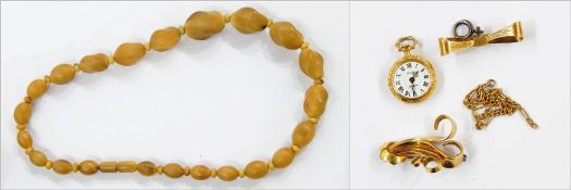 Gold-coloured metal abstract, scroll design brooch,