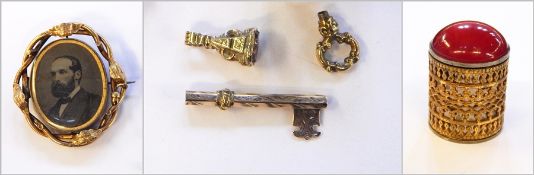 Gold-coloured metal seal inset pink stone with carved butterfly,