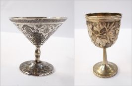 Eastern white metal egg cup raised on a circular foot,