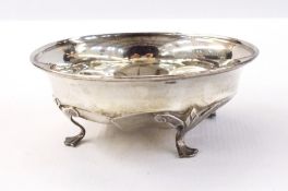 White metal dish of hexagonal form with a C-scroll border