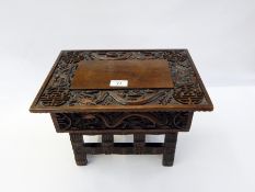 Chinese carved hardwood folding stool table with ornate dragon carving to the top and Oriental