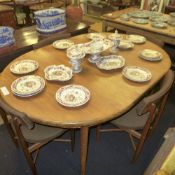 A G-plan style teak extending dining table with fitted extra leaf on tapered supports