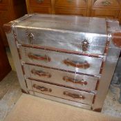 An aviator aluminium chest with hinged top above three drawers