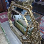 A French style gilded wall mirror with segmented border and central bevelled plate