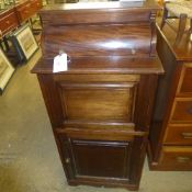 An Edwardian mahogany ships washstand with hinged top above cupboard