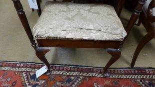 A walnut piano stool with pad seat on cabriole support