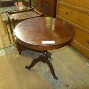 A C19th mahogany occasional table the circular top raised on tripod supports