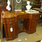 A Victorian mahogany pedestal desk the shaped top above an arrangement of drawers